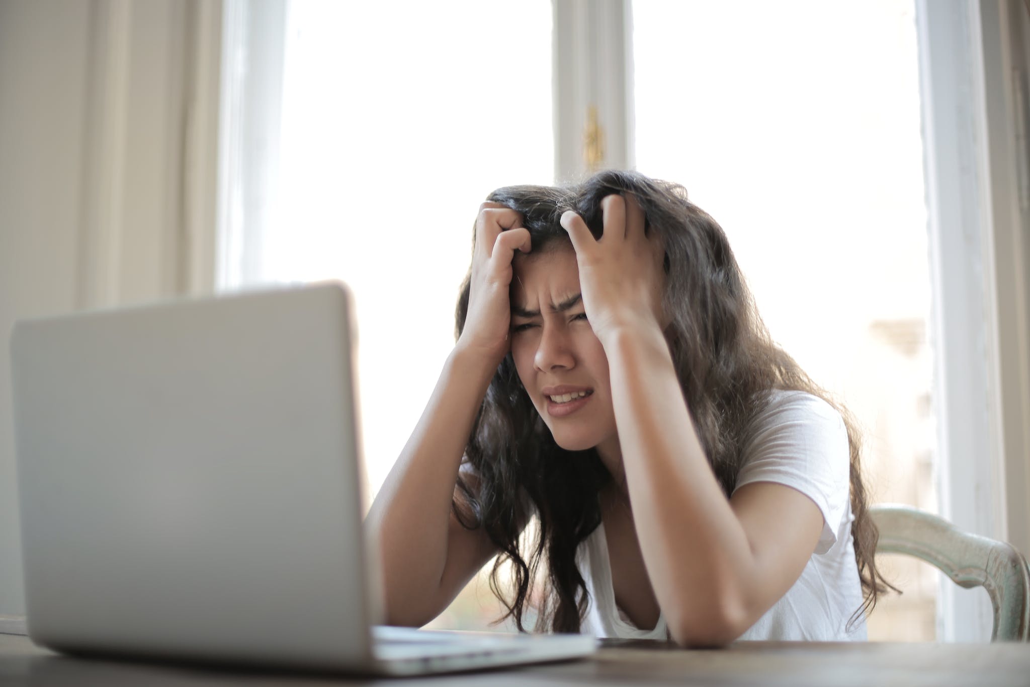 Rechtenvrije foto van gefrustreerde vrouw achter laptop.